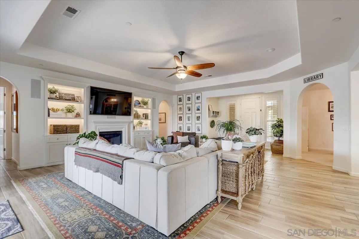 5620 Rancho Del Caballo Bonsall, CA 92003 - Photo 10 of 49 a living room with furniture a fireplace and a flat screen tv