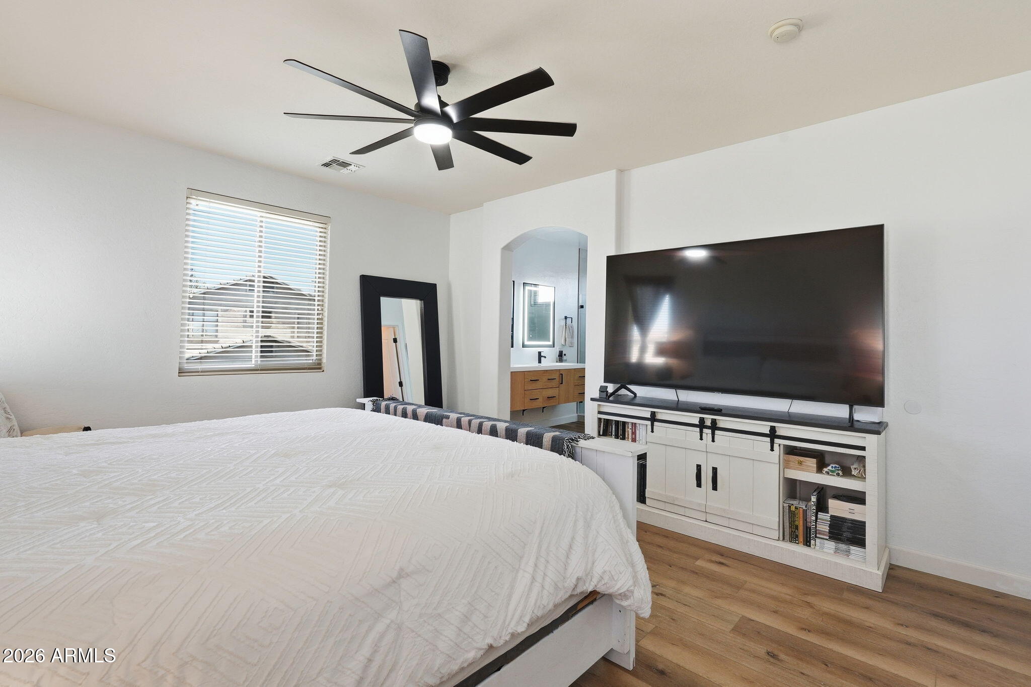 4184 East Trigger Way Gilbert, AZ 85297 - Photo 21 of 51 a bedroom with a bed and a flat screen tv on dresser
