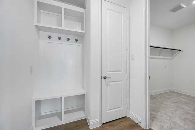 a view of walk in closet with empty racks