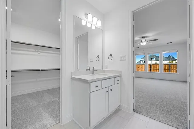 a spacious bathroom with a double vanity sink and a mirror