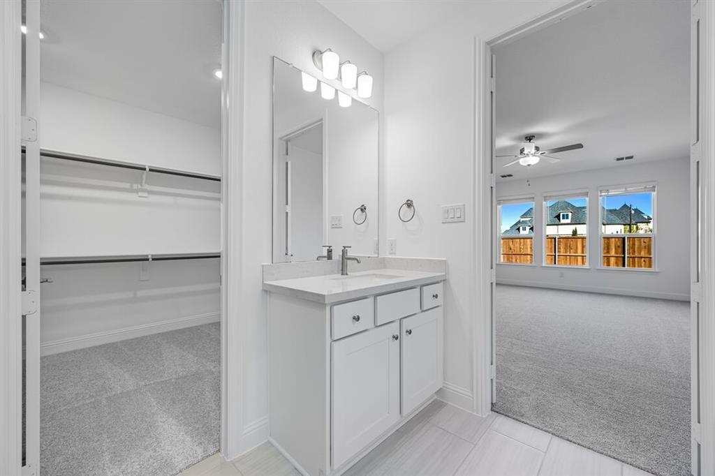 331 Trillium Street Oak Point, TX 75068 - Photo 19 of 36 a spacious bathroom with a double vanity sink and a mirror