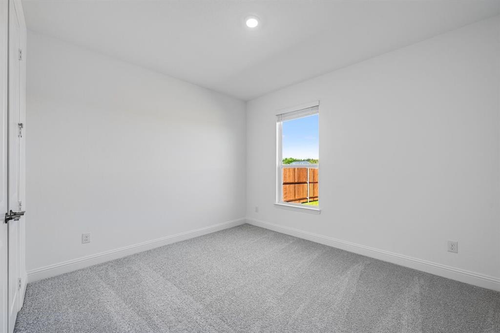 331 Trillium Street Oak Point, TX 75068 - Photo 21 of 36 an empty room with a window