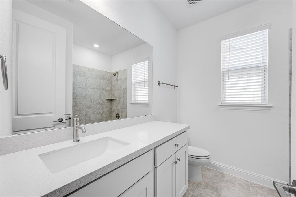 331 Trillium Street Oak Point, TX 75068 - Photo 22 of 36 a bathroom with a sink and a toilet