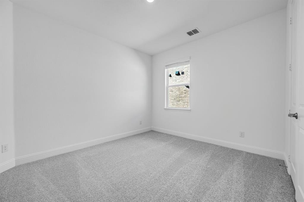 331 Trillium Street Oak Point, TX 75068 - Photo 23 of 36 an empty room with a window