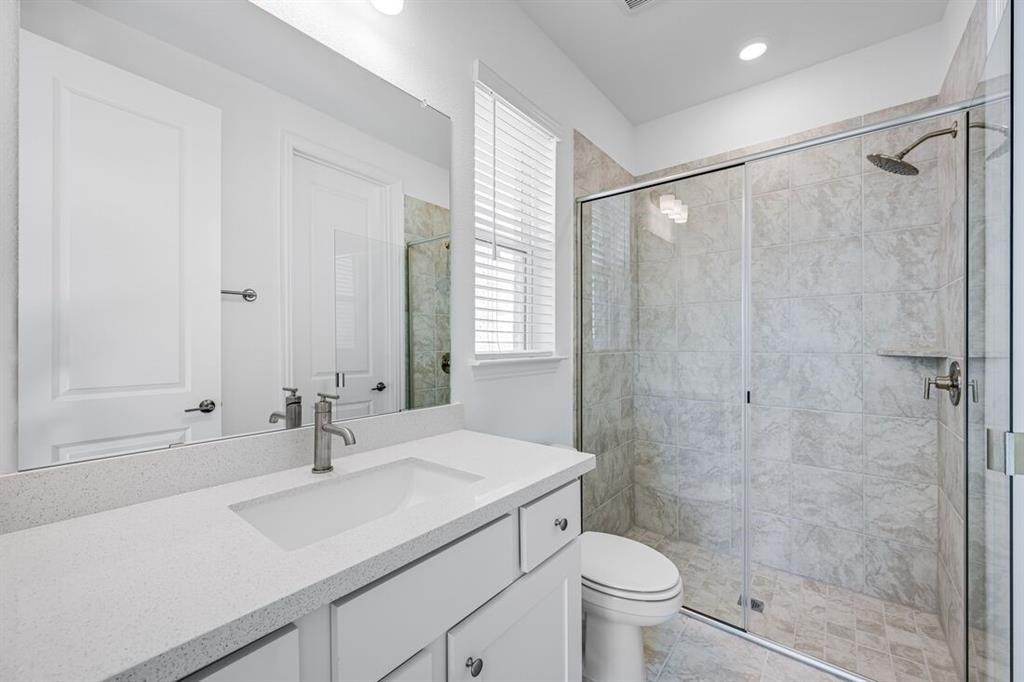 331 Trillium Street Oak Point, TX 75068 - Photo 26 of 36 a bathroom with a sink toilet and shower