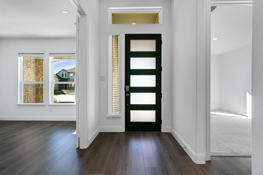 331 Trillium Street Oak Point, TX 75068 - Photo 5 of 36 an empty room with wooden floor and windows