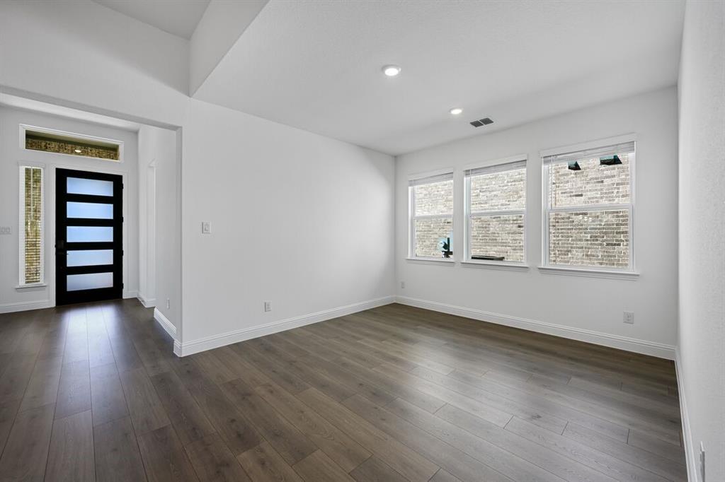 331 Trillium Street Oak Point, TX 75068 - Photo 7 of 36 an empty room with wooden floor and windows