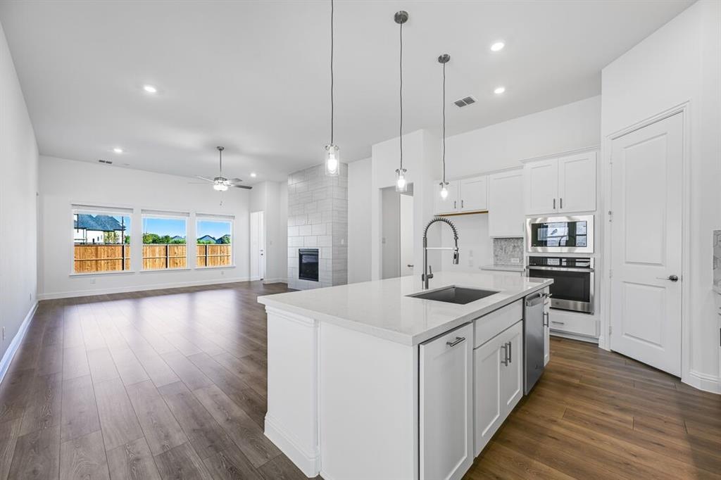 331 Trillium Street Oak Point, TX 75068 - Photo 10 of 36 a kitchen with stove a sink and refrigerator