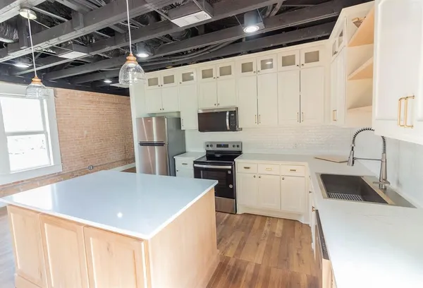 a kitchen with a sink a stove and a refrigerator