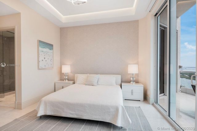 a bedroom with a bed and a night stand