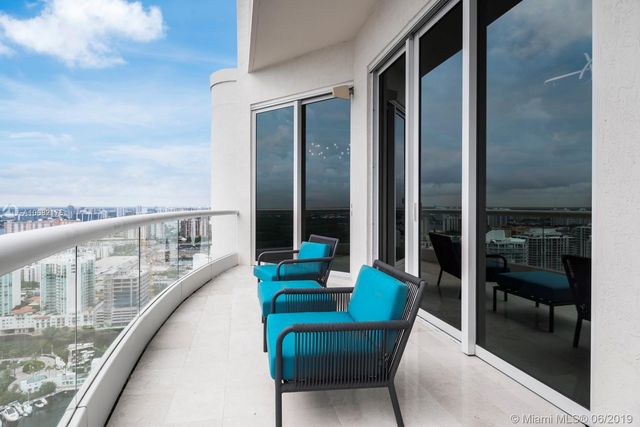 a balcony with furniture and a potted plant