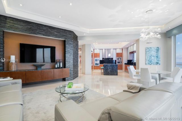 a living room with furniture and a large mirror