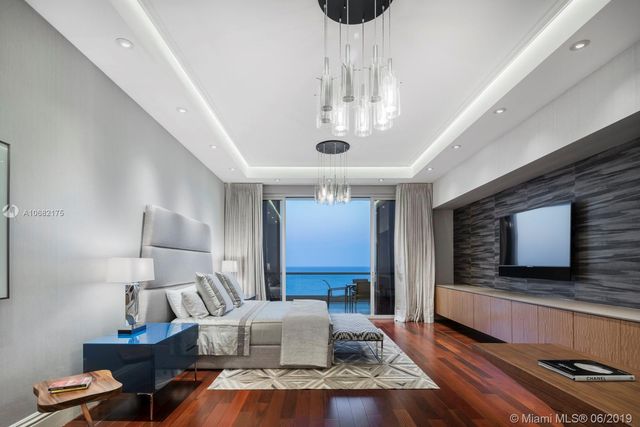 a living room with fireplace furniture and a flat screen tv