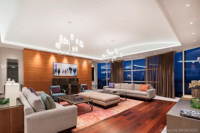 a living room with furniture or chandelier and a flat screen tv