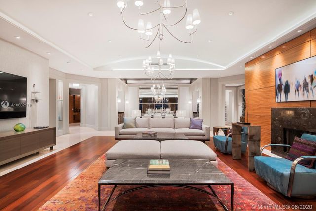 a large kitchen with stainless steel appliances granite countertop a large counter top a stove and a refrigerator