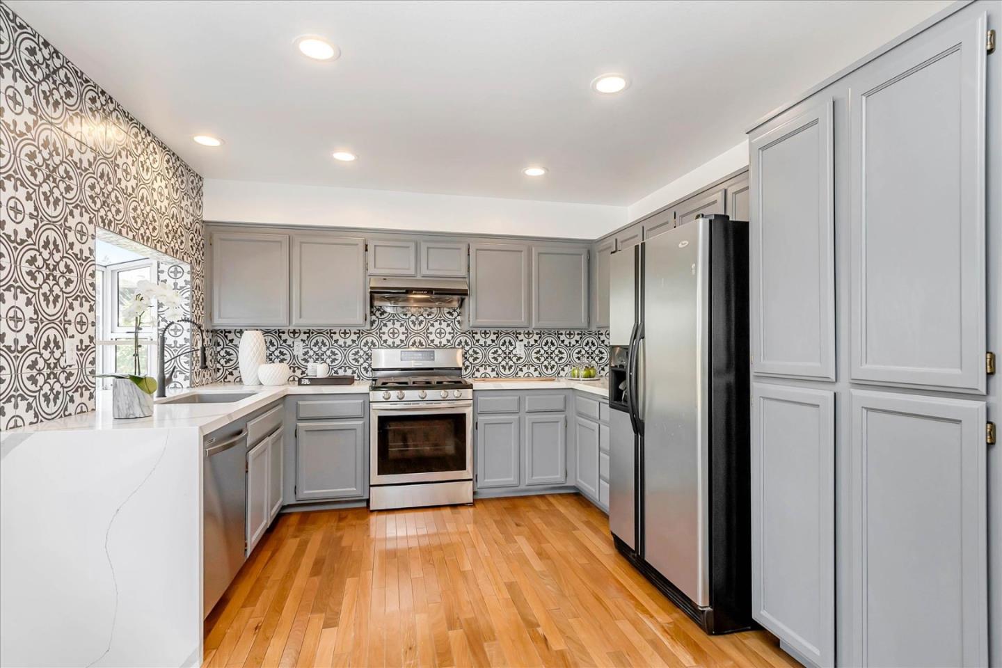 1483 Chavez Way San Jose, CA 95131 - Photo 12 of 40 a kitchen with stainless steel appliances granite countertop a refrigerator and a stove top oven