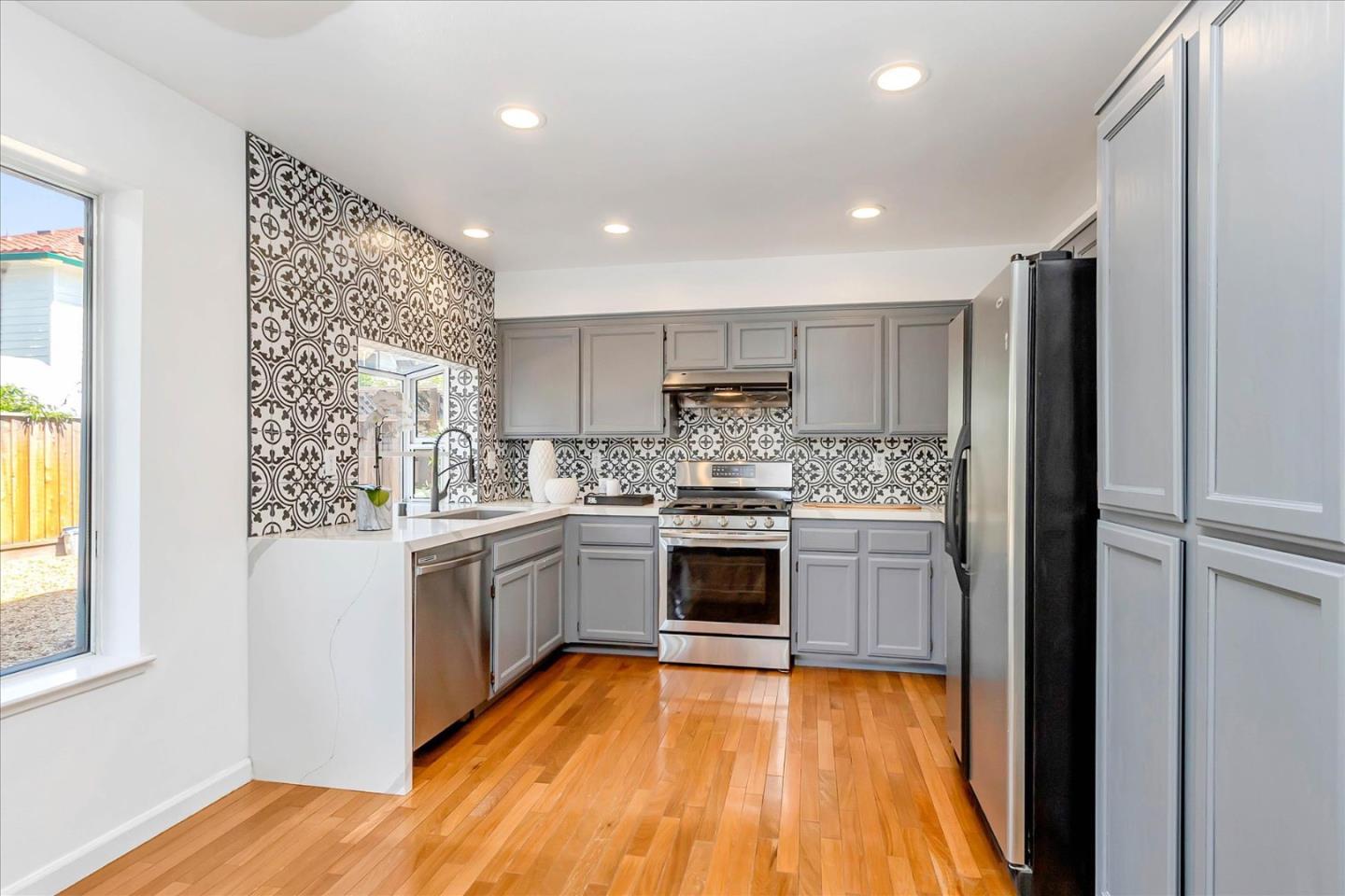 1483 Chavez Way San Jose, CA 95131 - Photo 22 of 40 a kitchen with a refrigerator and a stove top oven