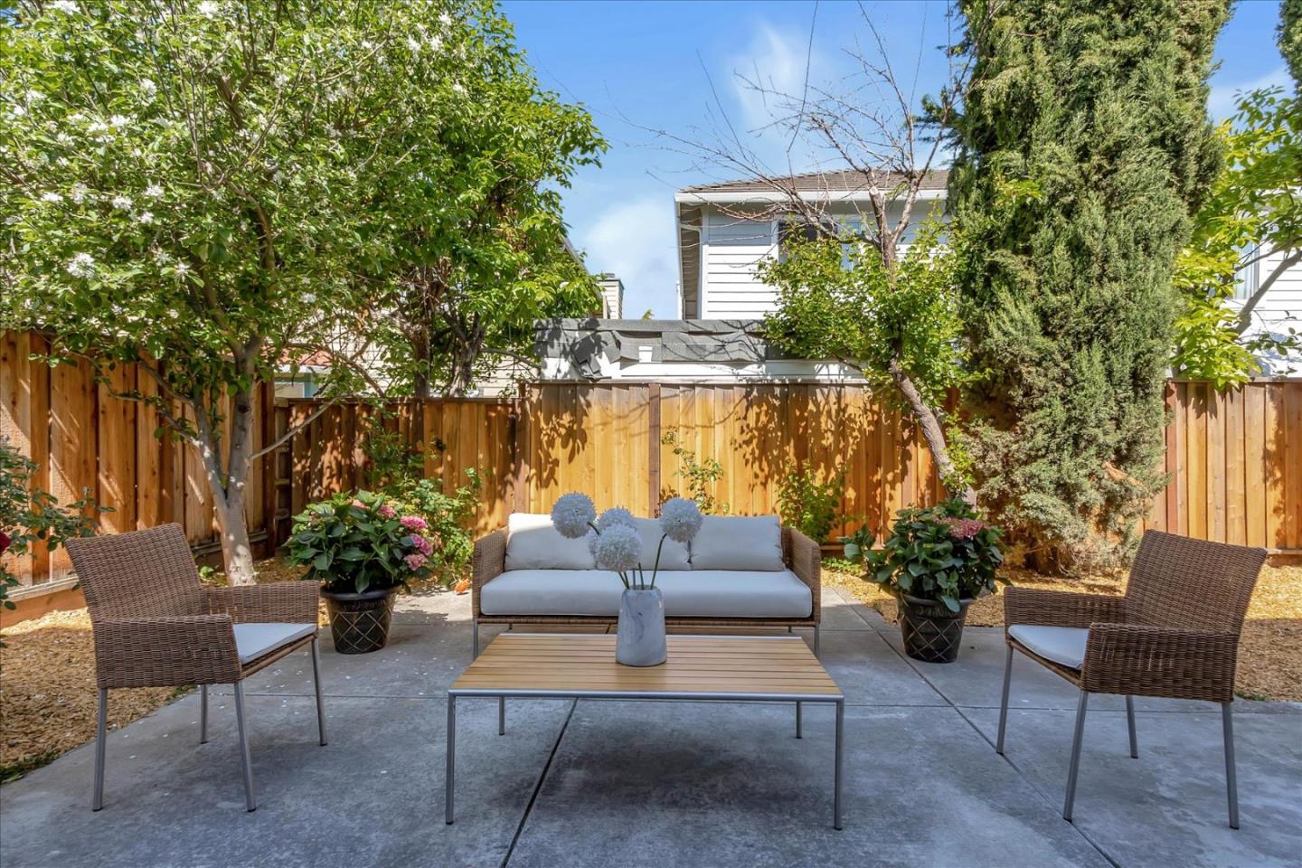 1483 Chavez Way San Jose, CA 95131 - Photo 37 of 40 a patio with couches and a table and chairs with potted plants and a large tree