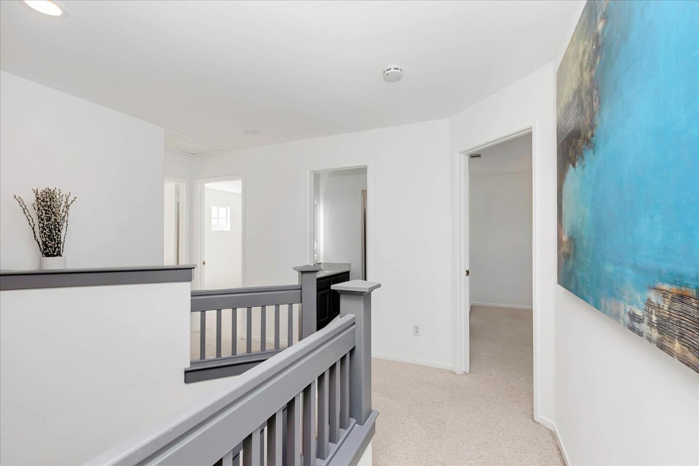 1483 Chavez Way San Jose, CA 95131 - Photo 8 of 40 a view of a hallway with wooden floor and windows