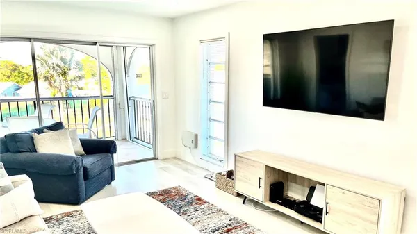 a living room with furniture fireplace and a flat tv screen