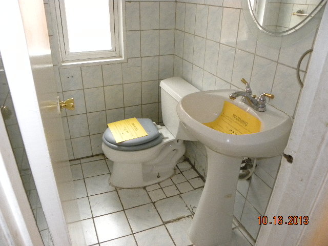10027 Frontage Road, Unit F Skokie, IL 60077 - Photo 3 of 13 a bathroom with a sink and a toilet
