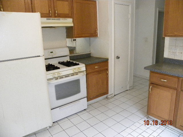 10027 Frontage Road, Unit F Skokie, IL 60077 - Photo 4 of 13 a kitchen with a stove top oven and cabinets