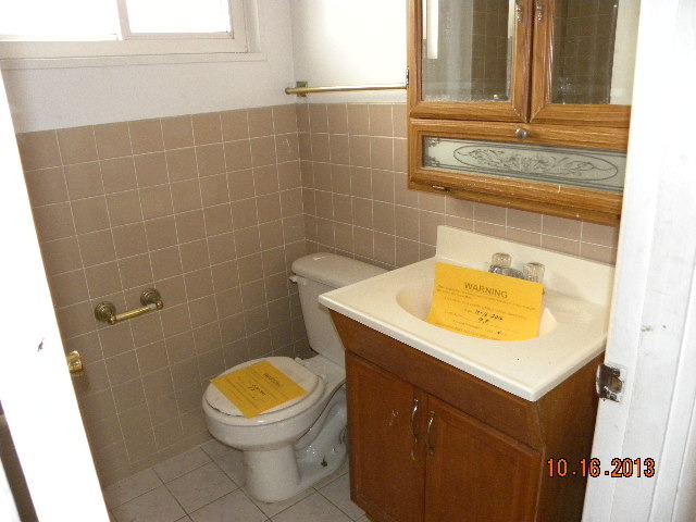 10027 Frontage Road, Unit F Skokie, IL 60077 - Photo 8 of 13 a bathroom with a sink and a toilet