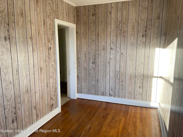 a view of wooden floor and brick walls