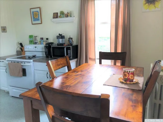 a dining room with a table and chairs in it