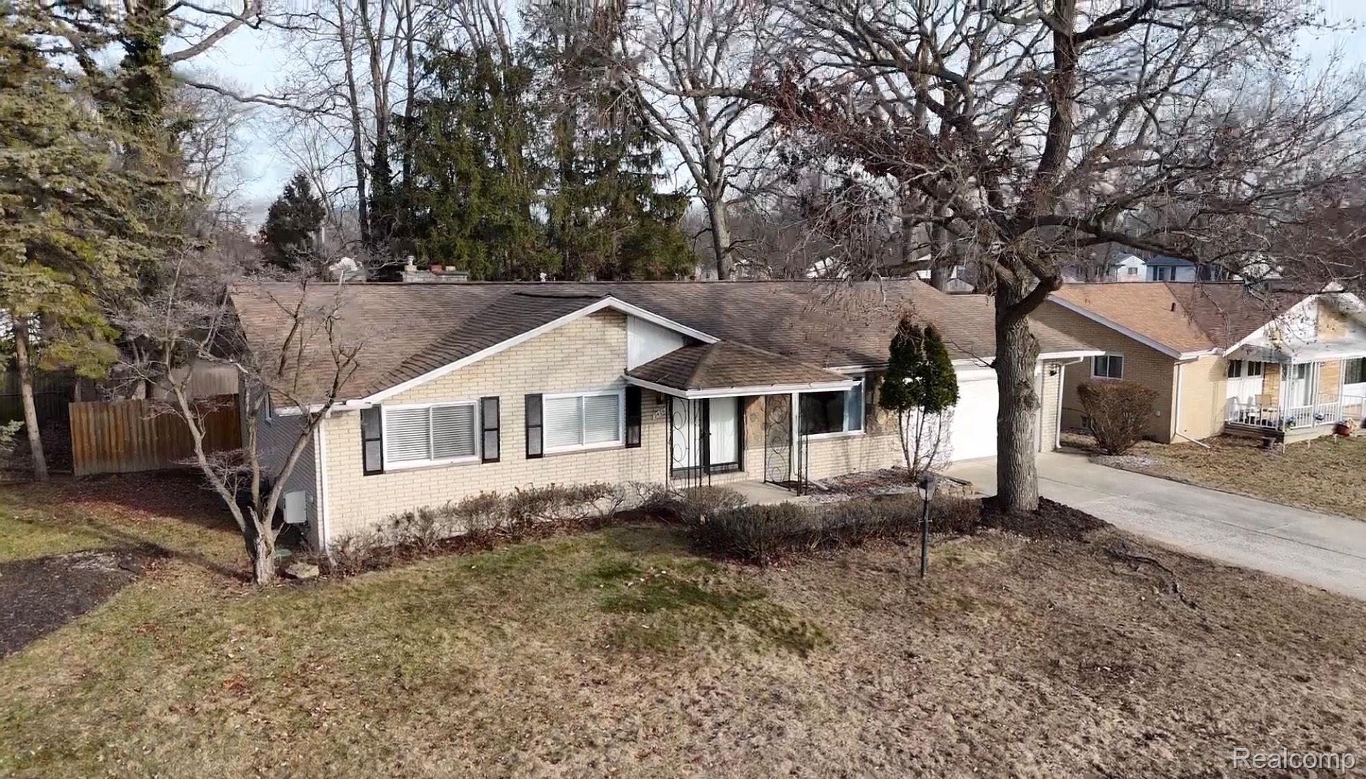 24065 Rockingham Street Southfield, MI 48033 - Photo 1 of 35 Ranch-style home featuring brick siding, a shingled roof, and concrete driveway