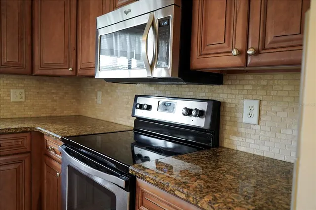 a kitchen with wooden cabinets and a stove top oven