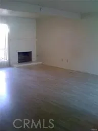 a view of empty room with a fireplace