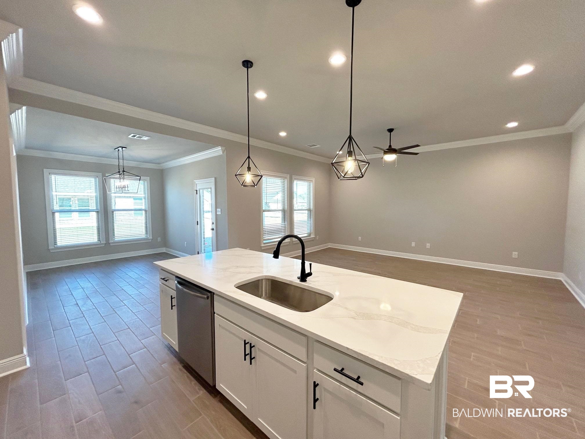 877 Sumter Loop Foley, AL 36535 - Photo 16 of 18 Kitchen featuring a sink, light wood-style flooring, stainless steel dishwasher, and open floor plan
