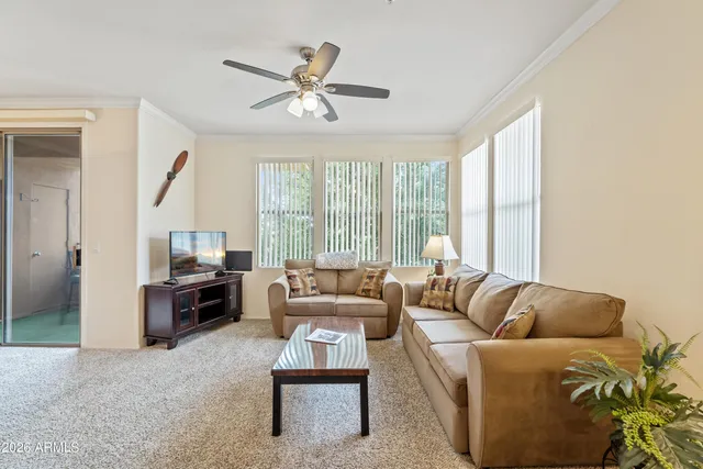a living room with furniture and a large window