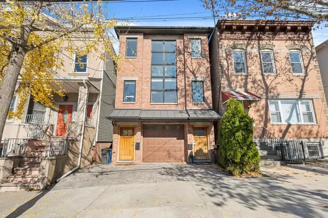 front view of a brick house with a large windows