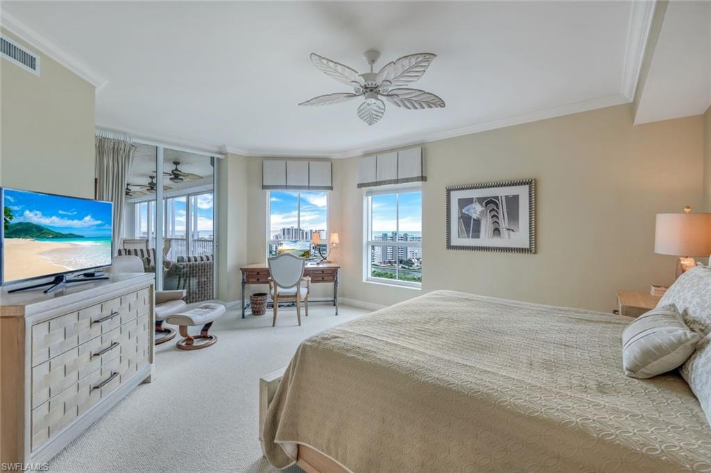295 Grande Way, Unit 1202 Naples, FL 34110 - Photo 16 of 36 a bedroom with furniture and a flat screen tv
