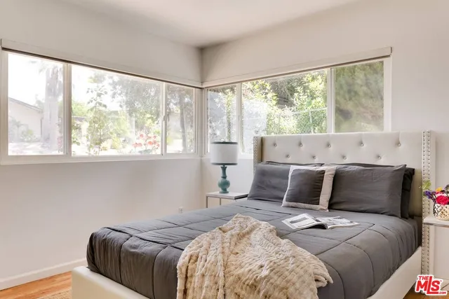 a bedroom with a large bed and a large window