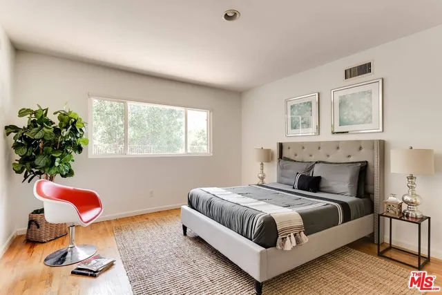 a spacious bedroom with a bed and a window