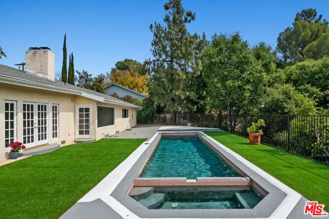 a view of a backyard with a garden and plants