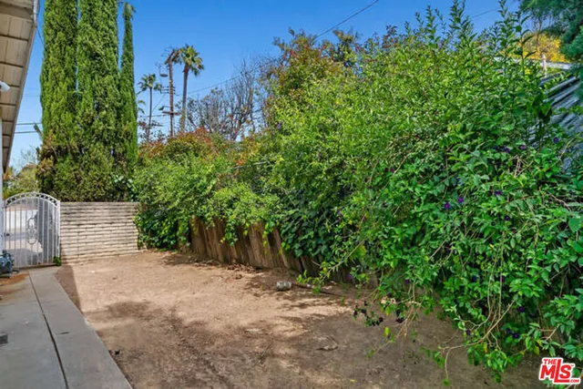 a view of pool with a yard