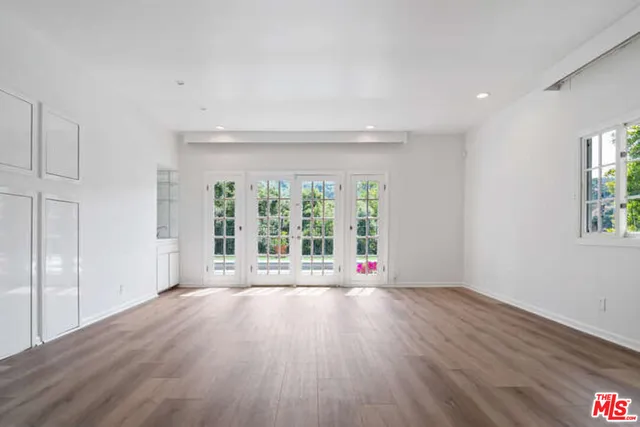 a view of a refrigerator in kitchen and wooden cabinets