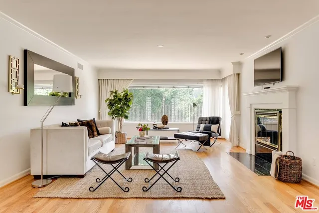 a living room with fireplace furniture and a flat screen tv