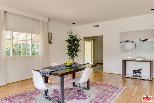 a dining room with furniture and wooden floor