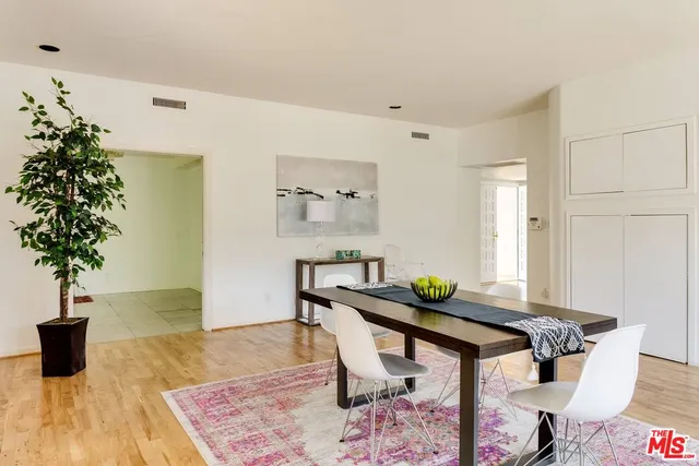 a living room with furniture and potted plant