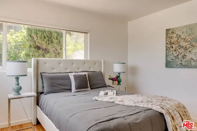 a bedroom with a large bed and a window