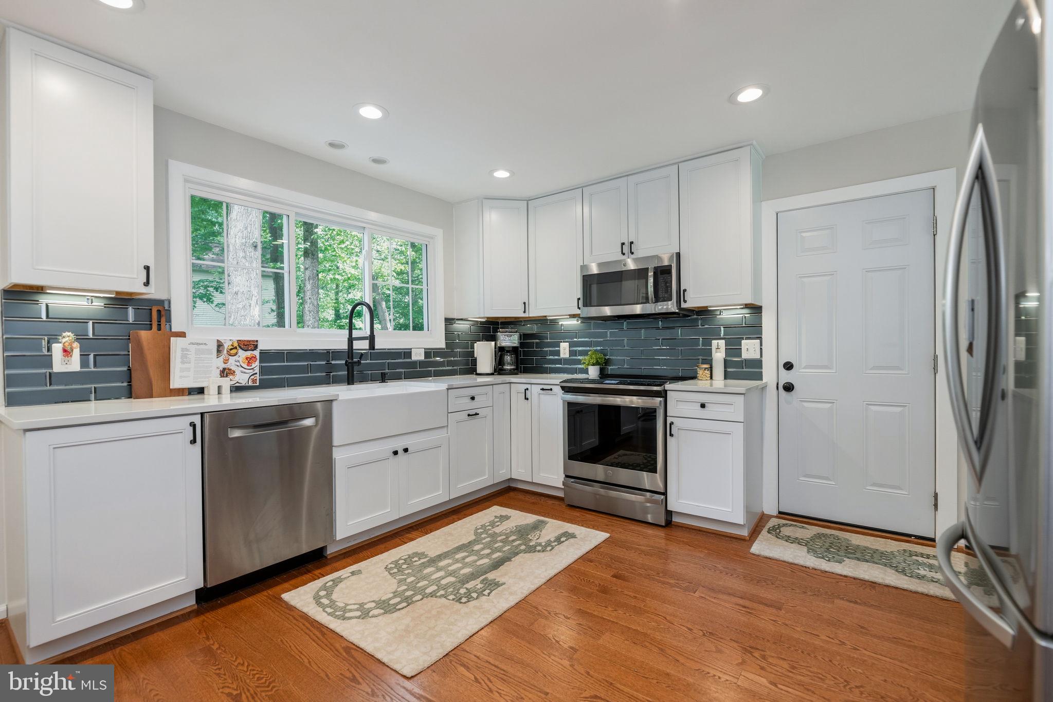 7603 Modisto Lane Springfield, VA 22153 - Photo 12 of 57 a kitchen with a sink stove and refrigerator