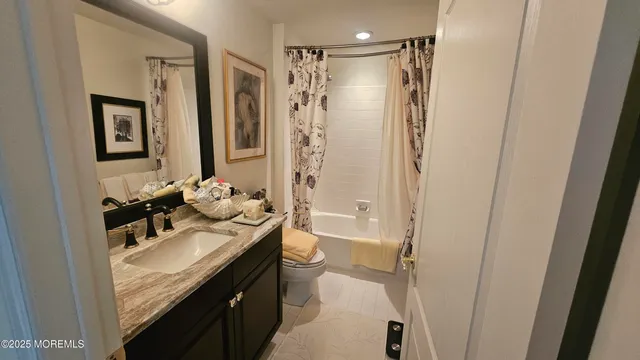 a view of a street with a yard and a large tree