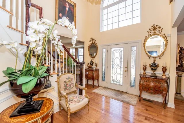 a living room with furniture a chandelier and a window