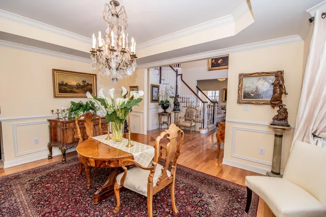 a view of a dining room with furniture and a chandelier
