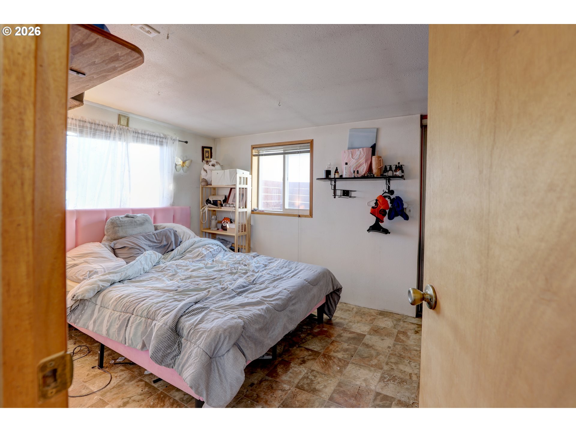 80165 Ridgetop Road Dufur, OR 97021 - Photo 18 of 43 a bed sitting in a bedroom next to a window